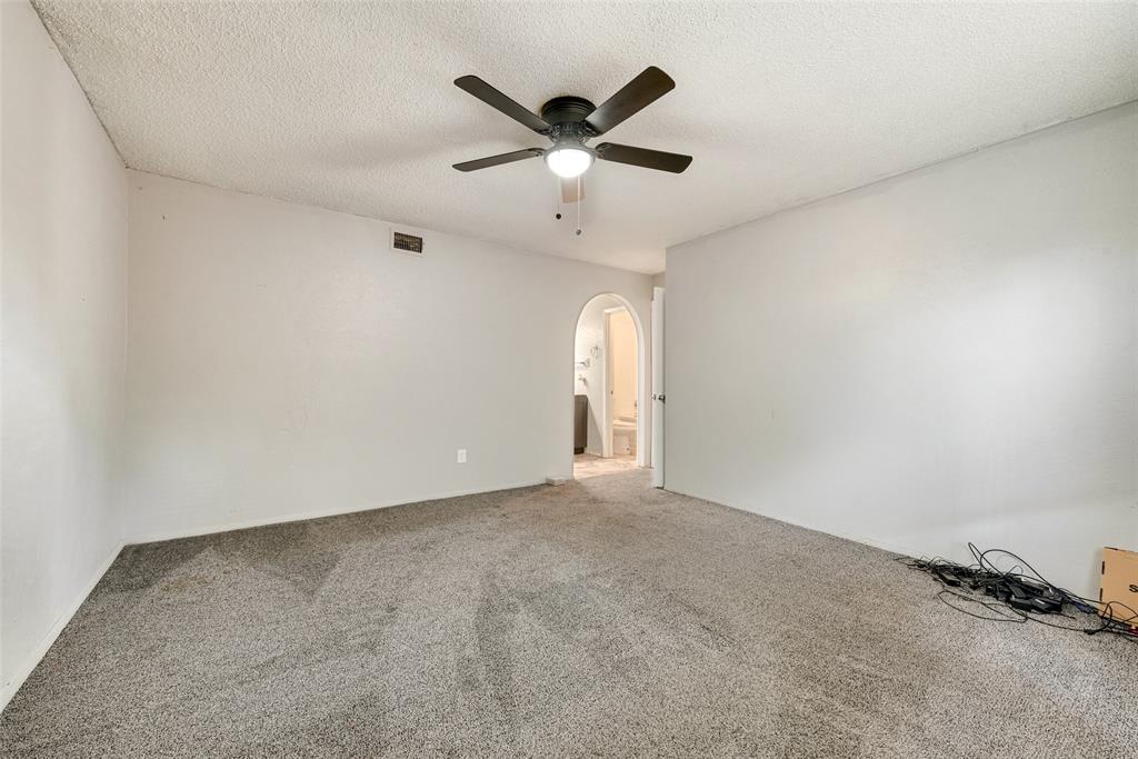 711 Valley Hill Road Duncanville, TX 75137 - Photo 11 of 20 an empty room with ceiling fan and windows