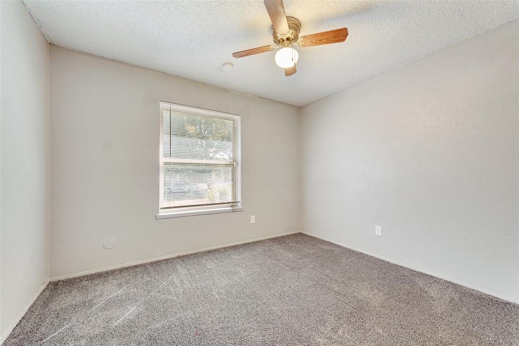 711 Valley Hill Road Duncanville, TX 75137 - Photo 16 of 20 an empty room with a window and a fan