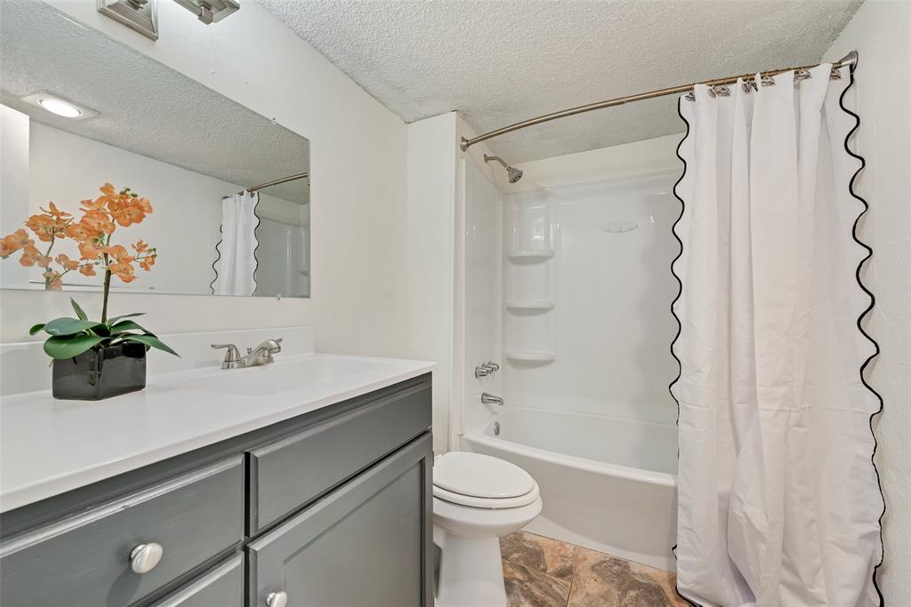 711 Valley Hill Road Duncanville, TX 75137 - Photo 17 of 20 a bathroom with a sink a toilet and a shower