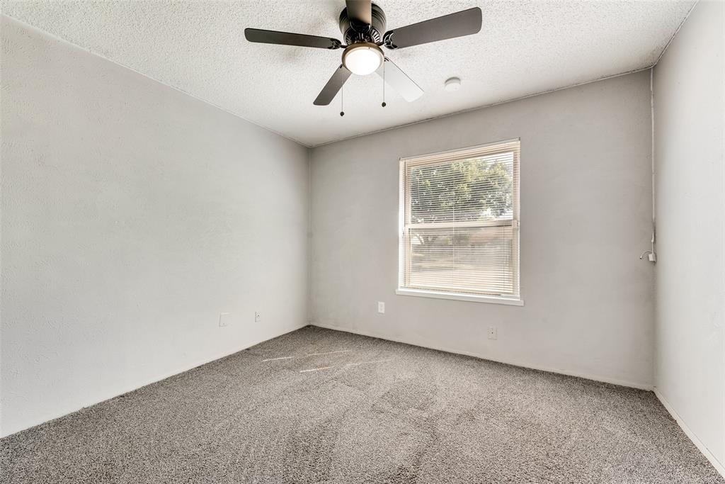 711 Valley Hill Road Duncanville, TX 75137 - Photo 18 of 20 an empty room with a window and a fan