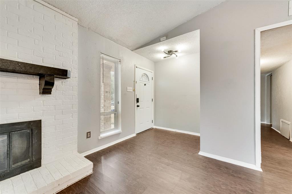 711 Valley Hill Road Duncanville, TX 75137 - Photo 3 of 20 a view of a hallway with wooden floor and staircase