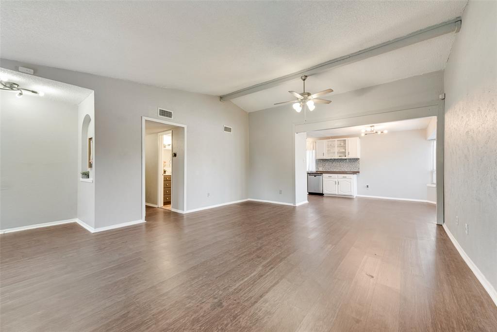 711 Valley Hill Road Duncanville, TX 75137 - Photo 4 of 20 a view of a kitchen with wooden floor and a ceiling fan