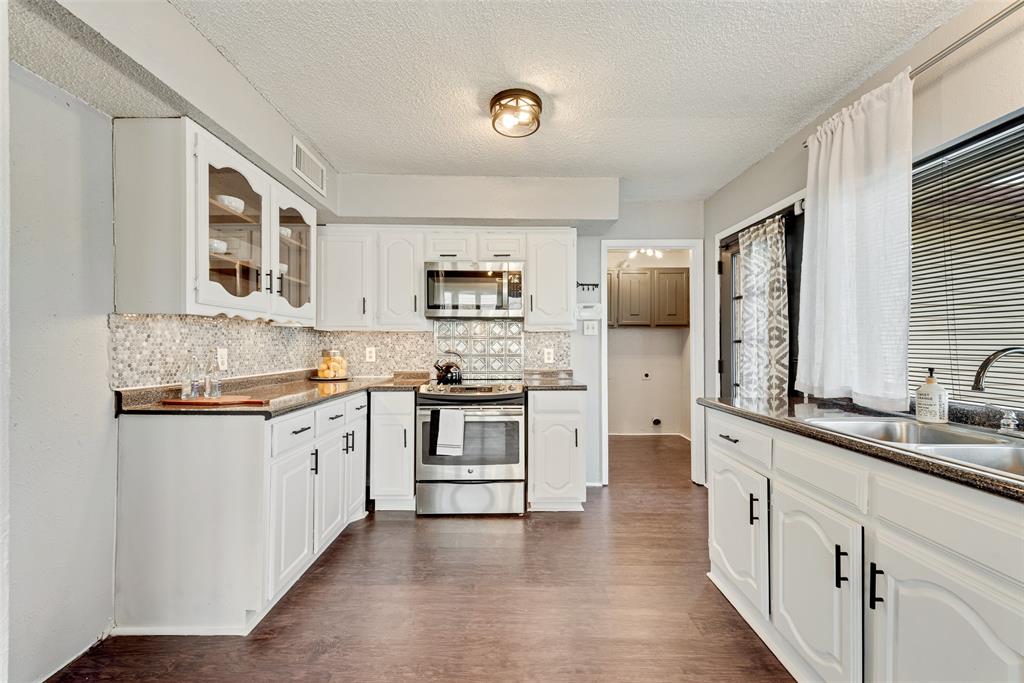 711 Valley Hill Road Duncanville, TX 75137 - Photo 7 of 20 a kitchen with stainless steel appliances granite countertop a stove sink and cabinets