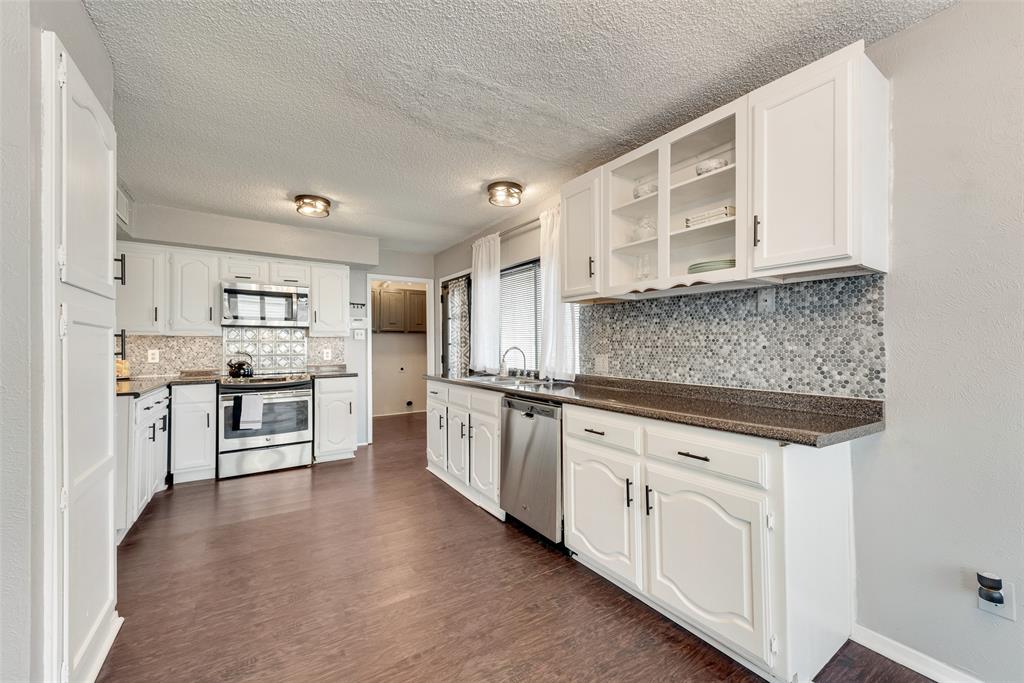 711 Valley Hill Road Duncanville, TX 75137 - Photo 8 of 20 a kitchen with stainless steel appliances granite countertop a stove sink and cabinets