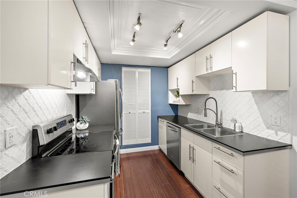 25611 Quail Run, Unit 131 Dana Point, CA 92629 - Photo 5 of 25 a kitchen with stainless steel appliances sink stove microwave and cabinets