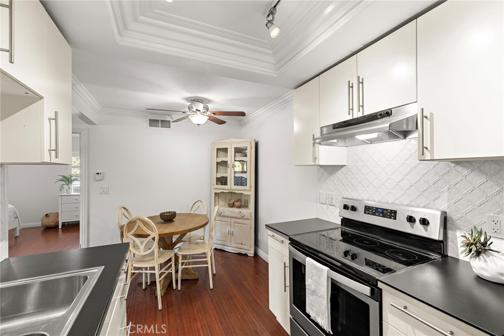 25611 Quail Run, Unit 131 Dana Point, CA 92629 - Photo 6 of 25 a kitchen with a stove and white cabinets