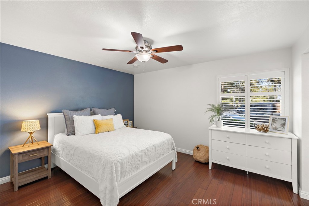 25611 Quail Run, Unit 131 Dana Point, CA 92629 - Photo 8 of 25 a bedroom with a bed and a chandelier