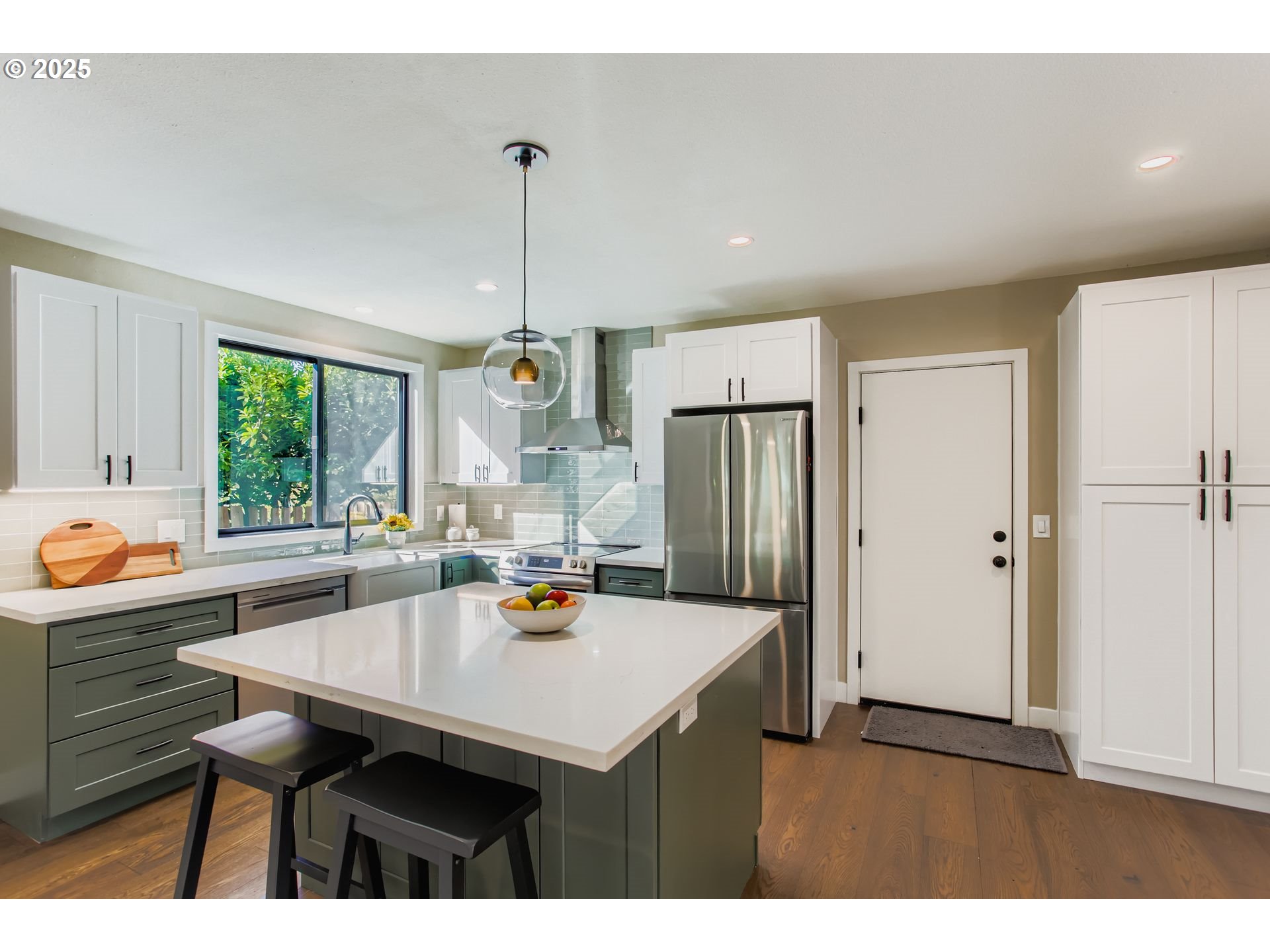 8409 Southwest Jamieson Road Portland, OR 97225 - Photo 14 of 28 a kitchen with a table chairs refrigerator and cabinets