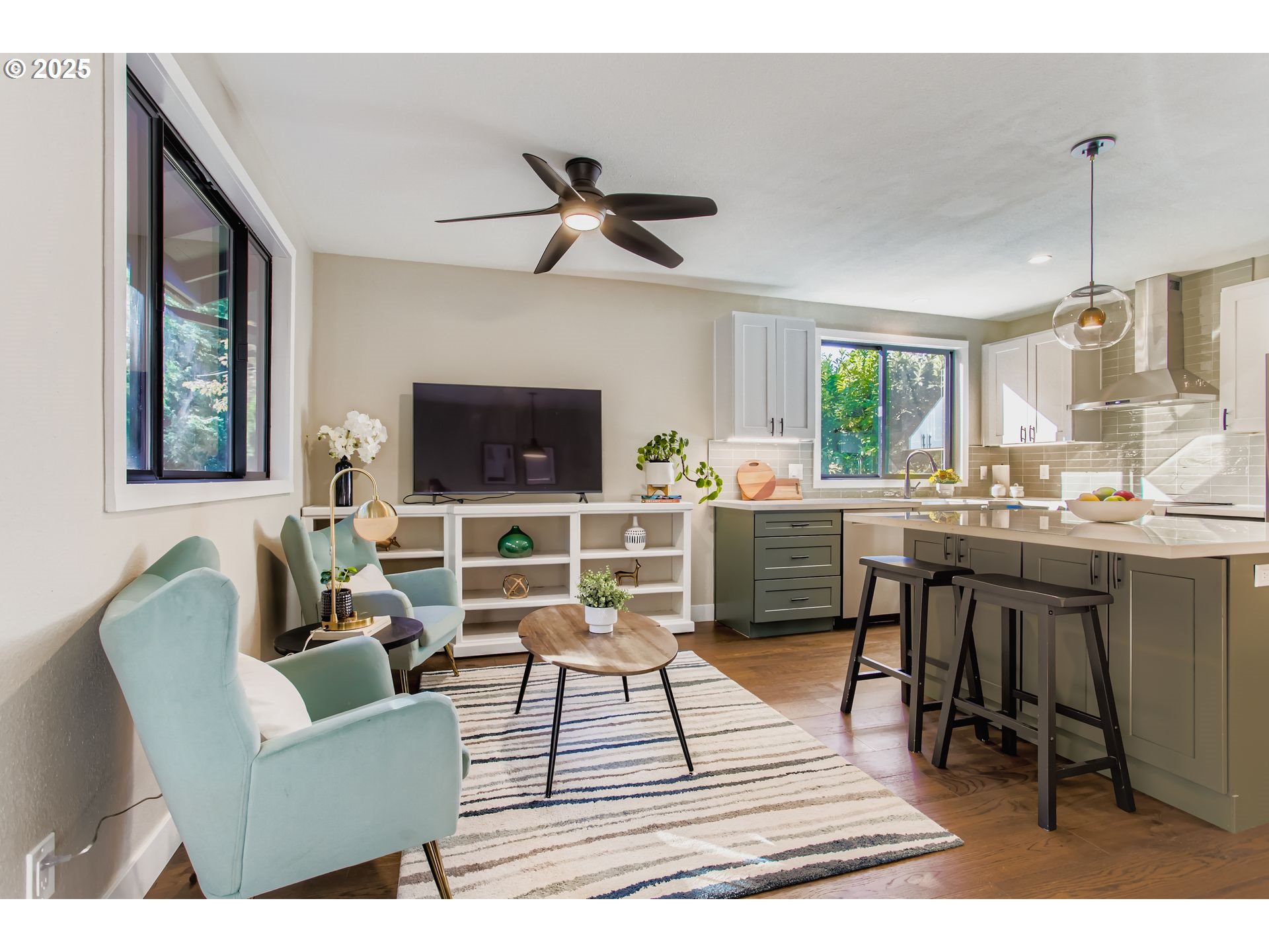 8409 Southwest Jamieson Road Portland, OR 97225 - Photo 15 of 28 a living room with furniture a flat screen tv and a dining table