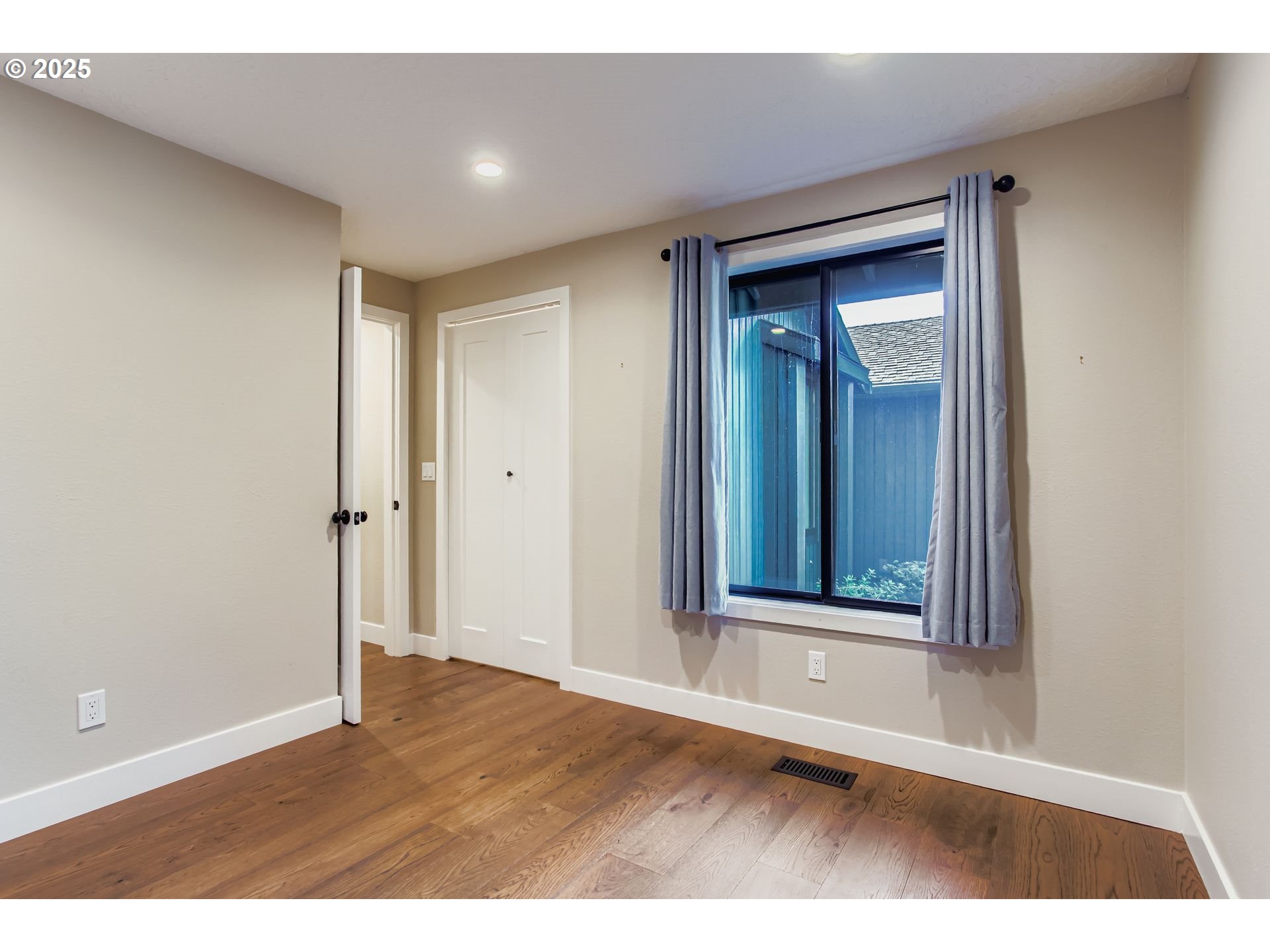 8409 Southwest Jamieson Road Portland, OR 97225 - Photo 24 of 28 a view of an empty room with wooden floor and closet