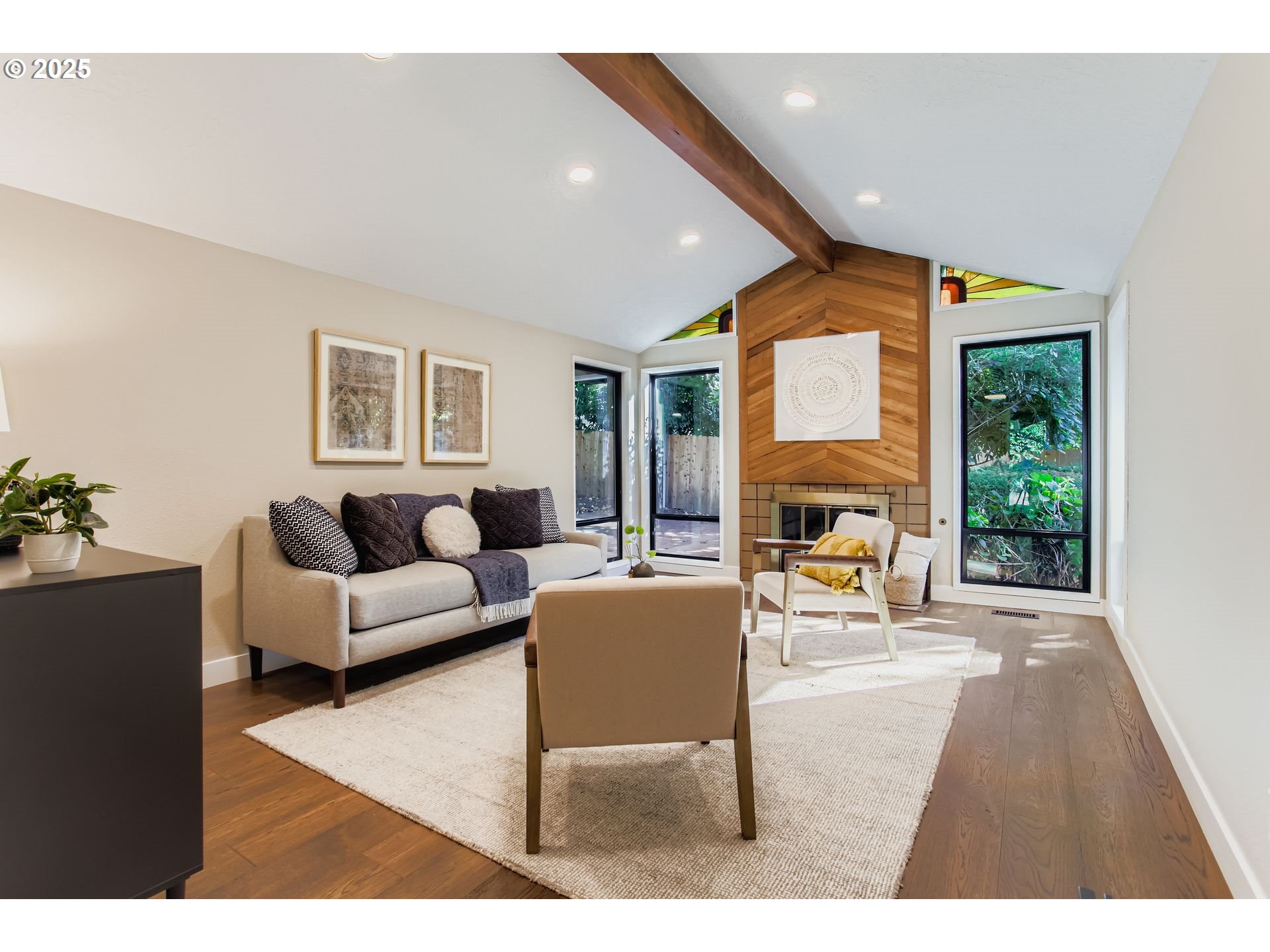 8409 Southwest Jamieson Road Portland, OR 97225 - Photo 5 of 28 a living room with furniture a large window and a fireplace