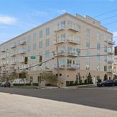 a large building with a street sign on the side of it