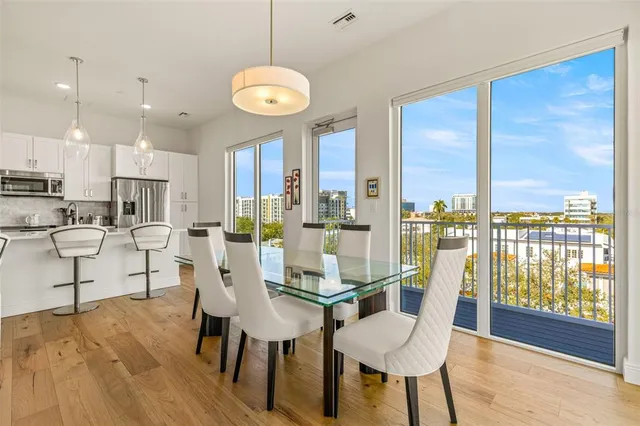 a view of a dining room with furniture window and wooden floor