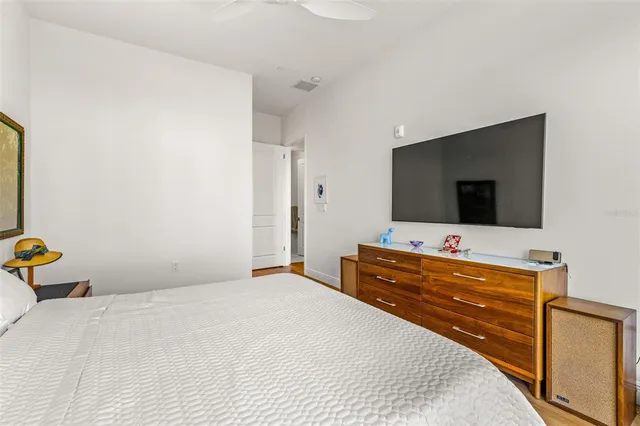 a bedroom with a bed and a flat screen tv