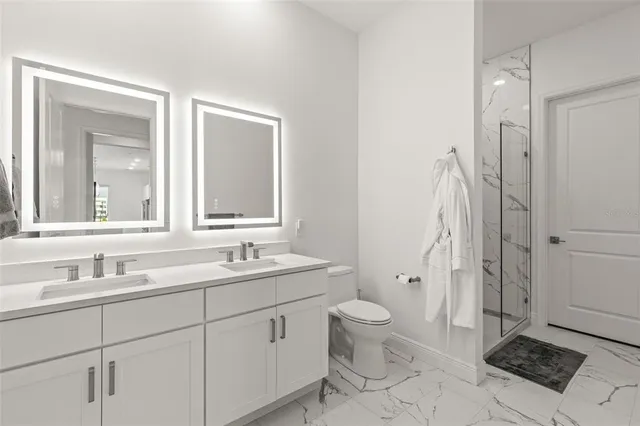 a bathroom with a sink a toilet and a mirror