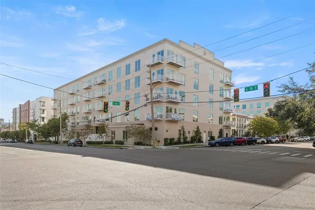 a view of a tall building next to a road