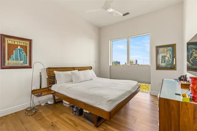 a bedroom with a bed and wooden floor