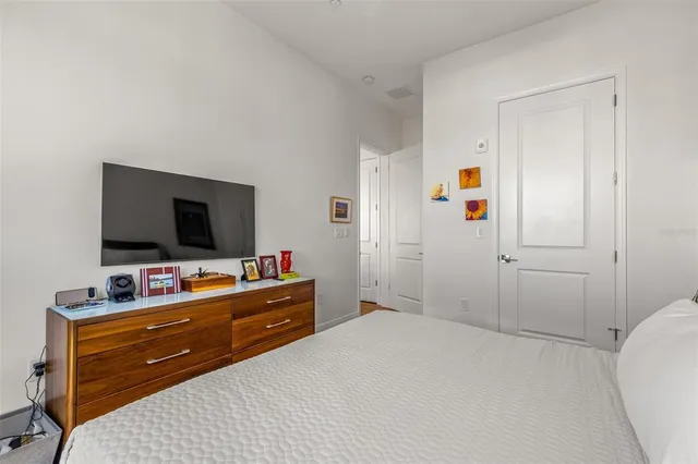 a bedroom with a bed and a flat screen tv