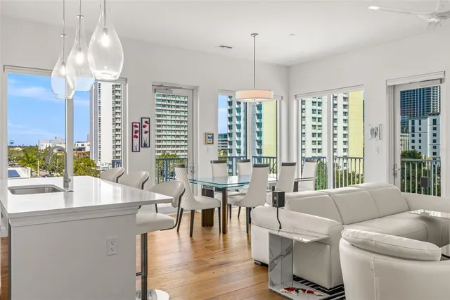 a living room with fireplace furniture and a large window
