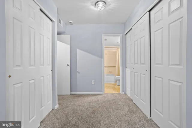 a view of a hallway with wooden shelves