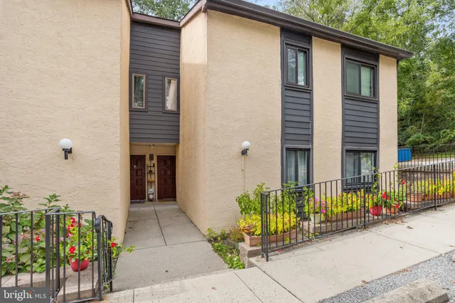 a view of a house with potted plants
