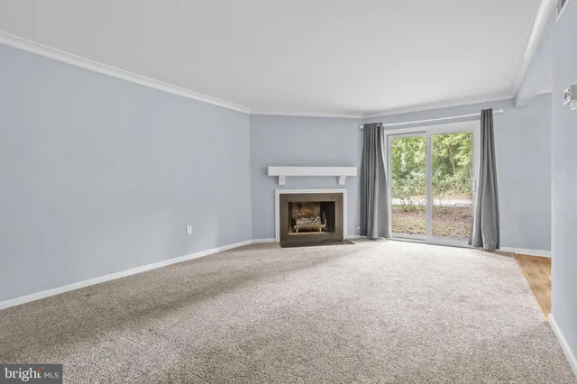 a view of empty room with a fireplace