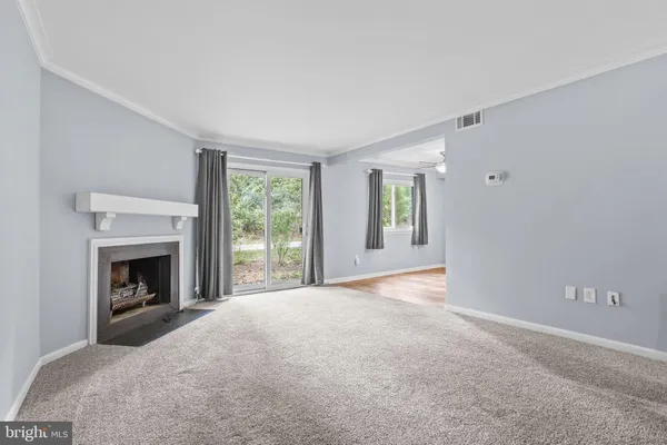 a view of empty room with window and fireplace