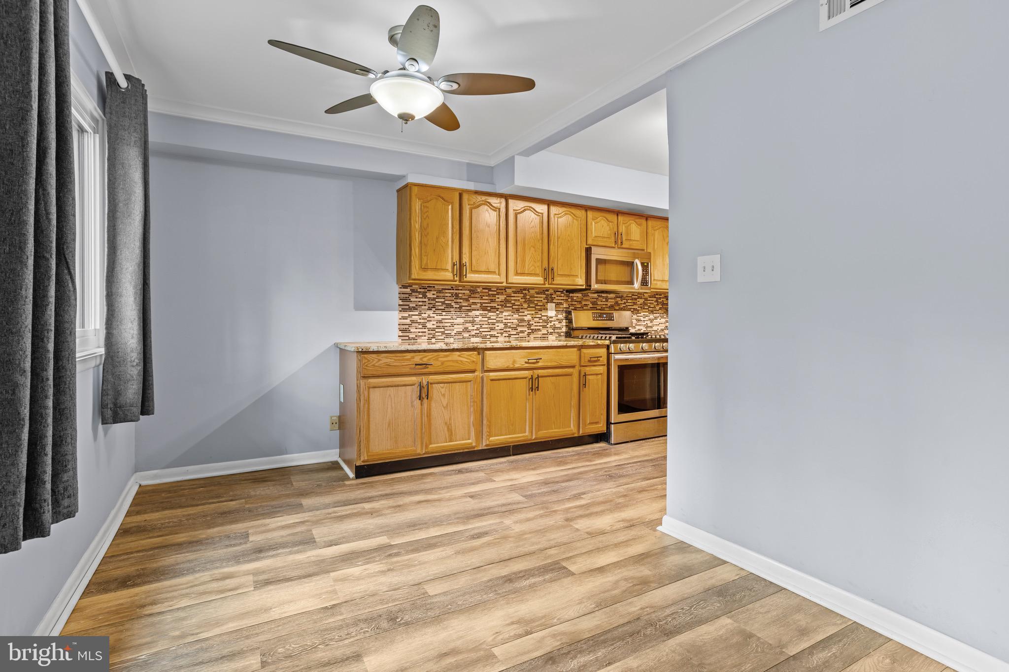 1511 Painters Crossing, Unit 1511 Chadds Ford, PA 19317 - Photo 6 of 17 a view of a kitchen with wooden floor a sink and a window