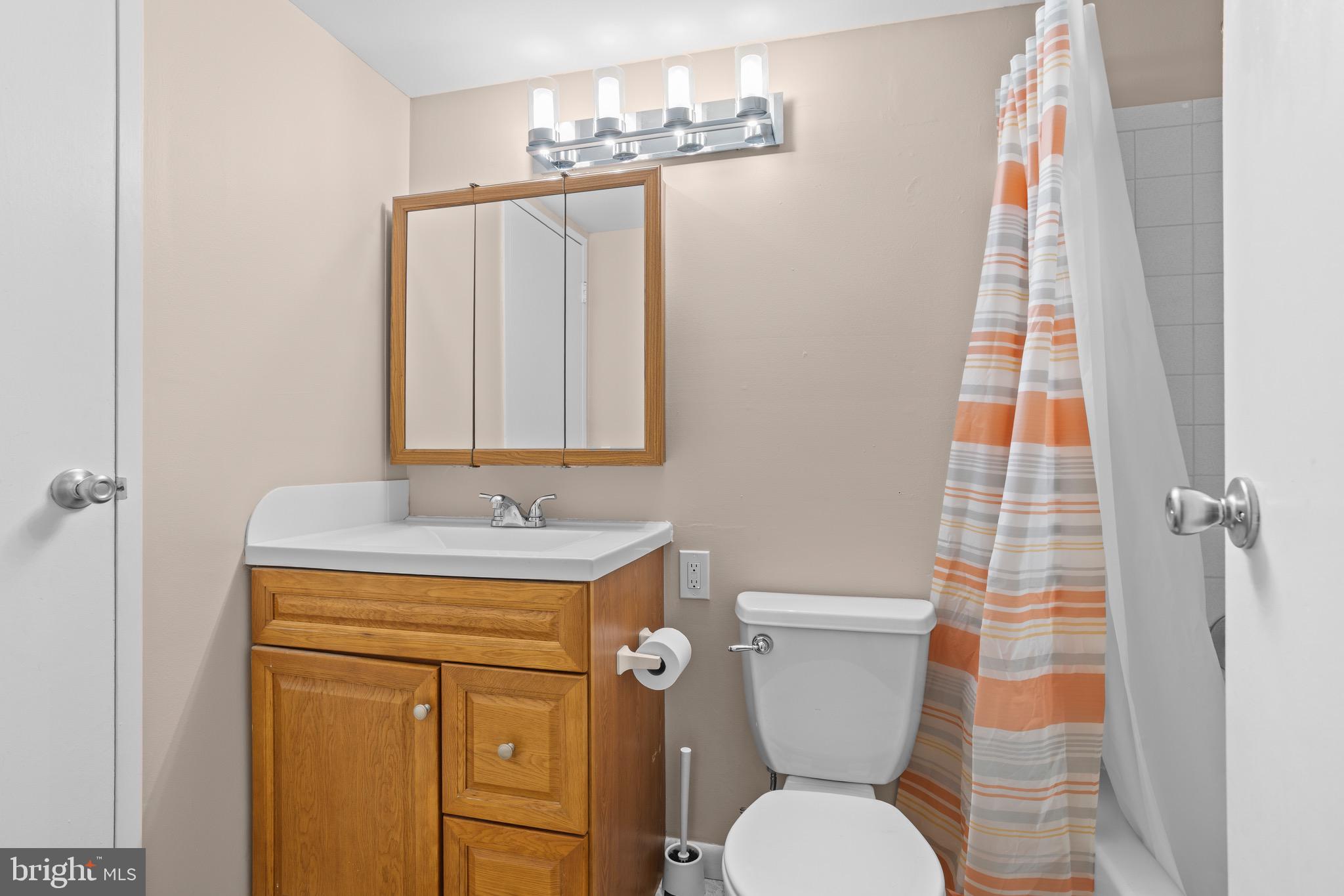 1511 Painters Crossing, Unit 1511 Chadds Ford, PA 19317 - Photo 10 of 17 a bathroom with a toilet sink and mirror