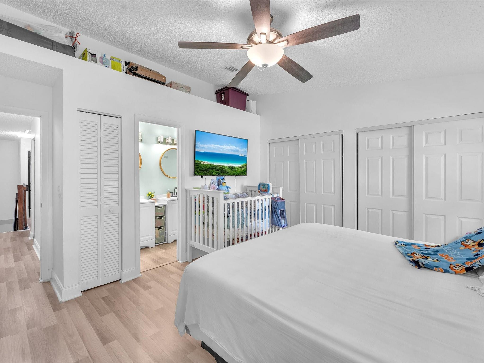 9831 Riverside Drive Coral Springs, FL 33071 - Photo 15 of 27 a bedroom with a bed ceiling fan and a window