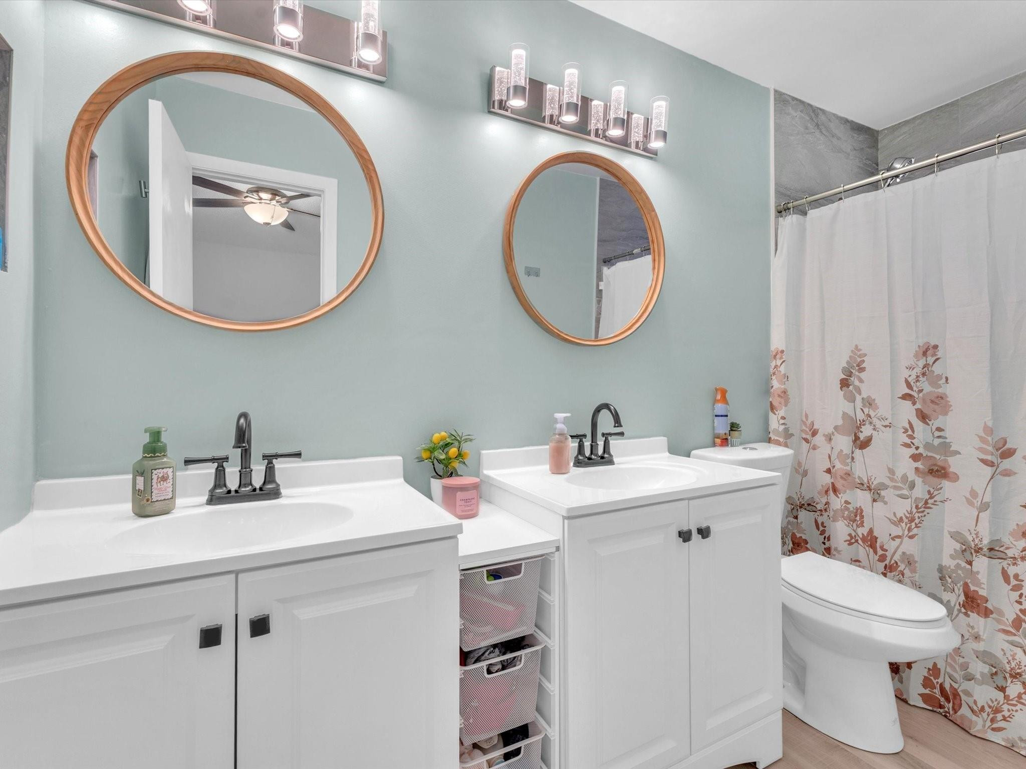 9831 Riverside Drive Coral Springs, FL 33071 - Photo 17 of 27 a bathroom with a toilet a sink and a mirror