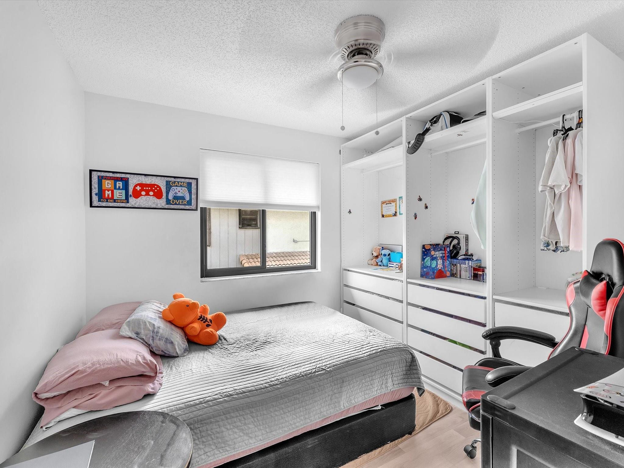 9831 Riverside Drive Coral Springs, FL 33071 - Photo 22 of 27 a bedroom with a bed and a desk