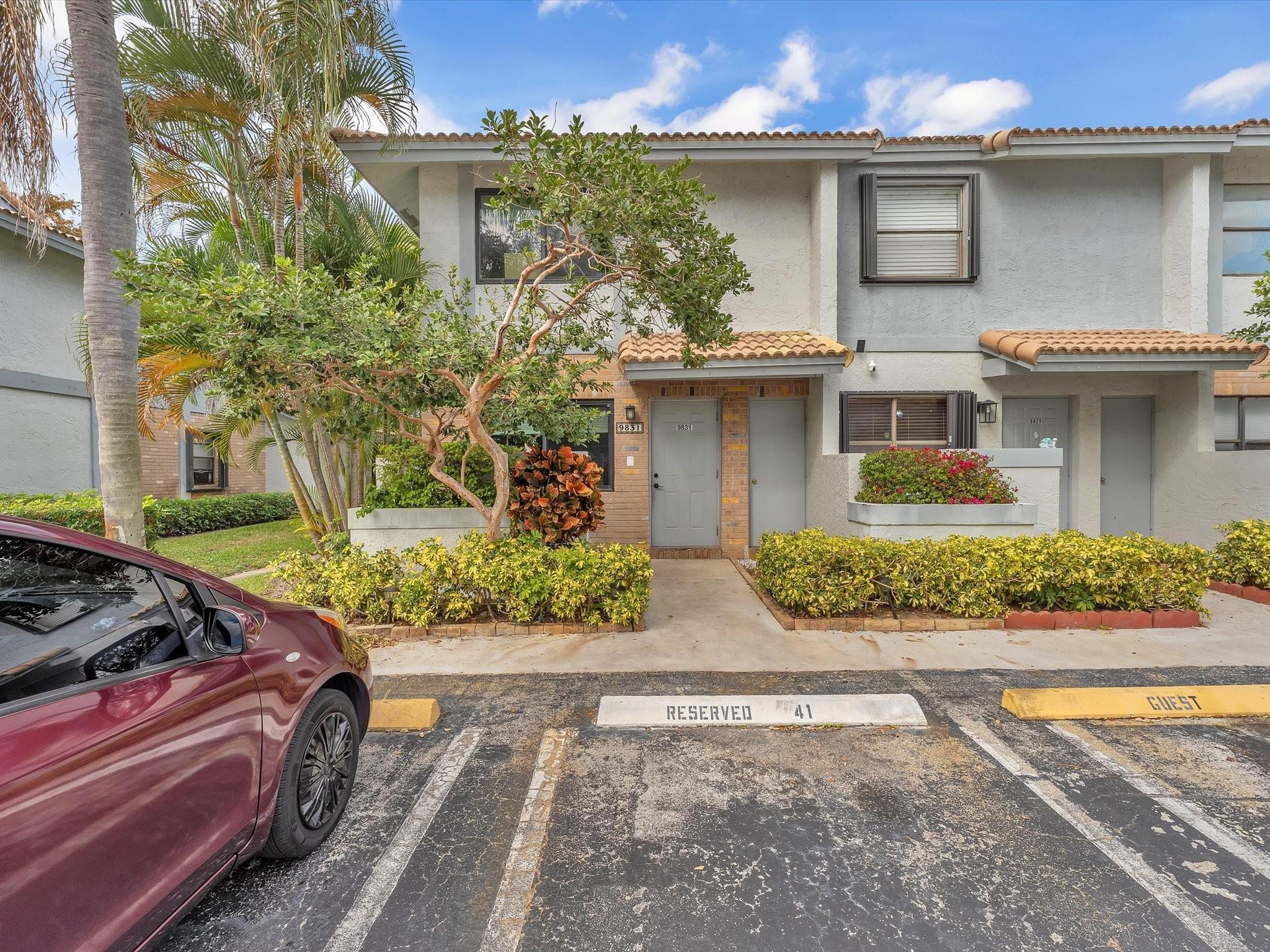 9831 Riverside Drive Coral Springs, FL 33071 - Photo 3 of 27 a front view of a house with garden