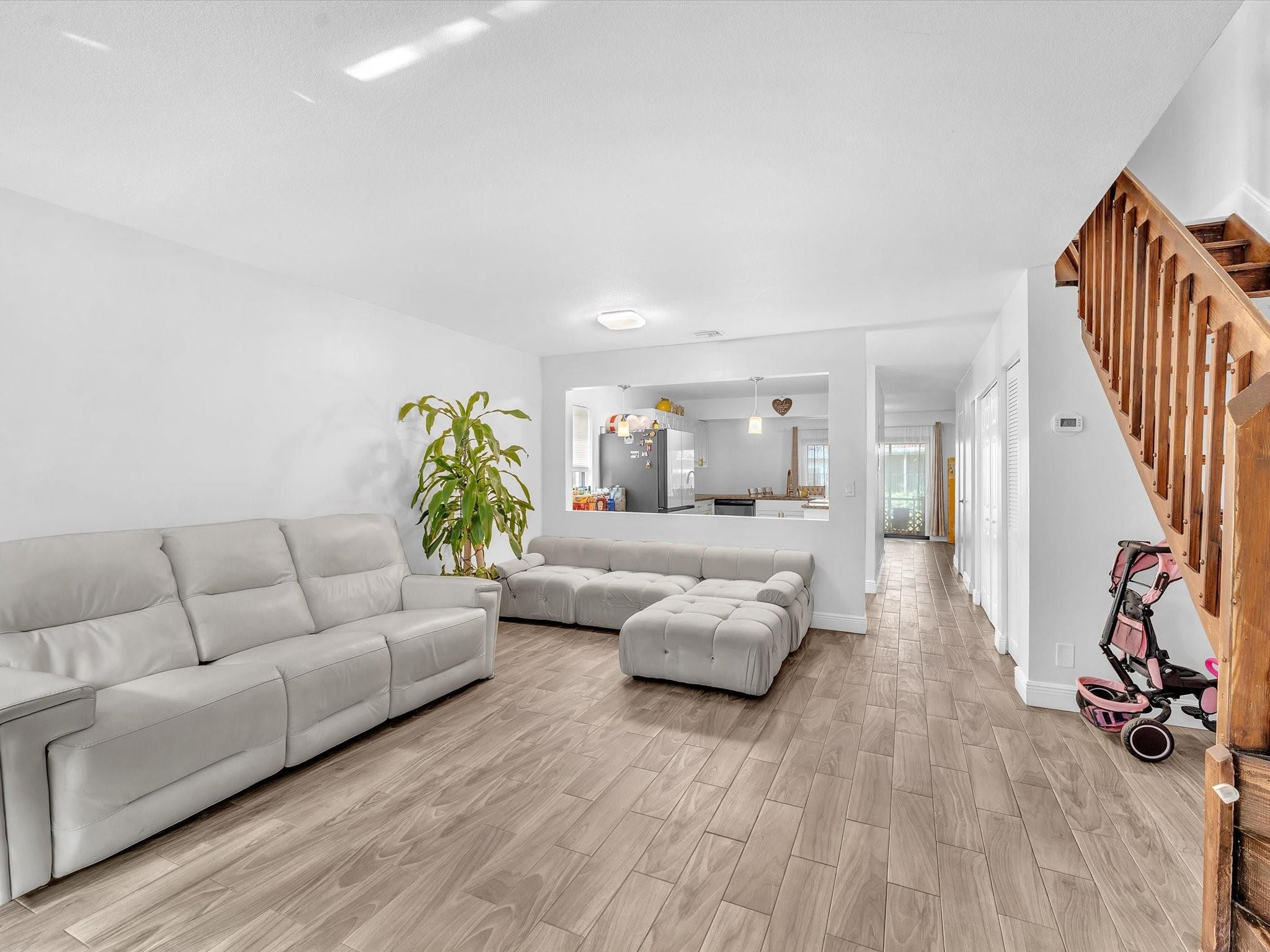 9831 Riverside Drive Coral Springs, FL 33071 - Photo 7 of 27 a living room with furniture and a wooden floor