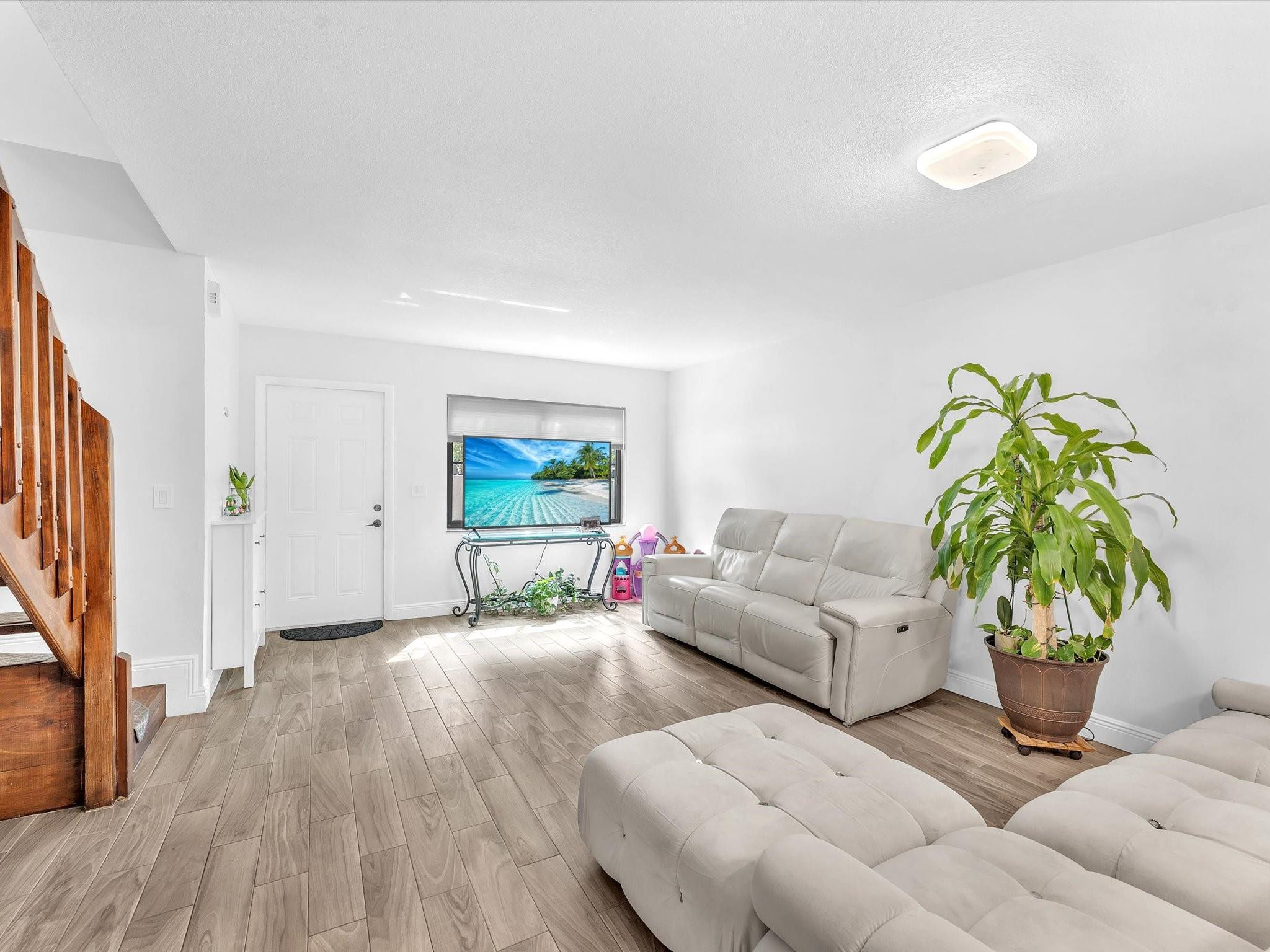 9831 Riverside Drive Coral Springs, FL 33071 - Photo 8 of 27 a living room with furniture and a potted plant