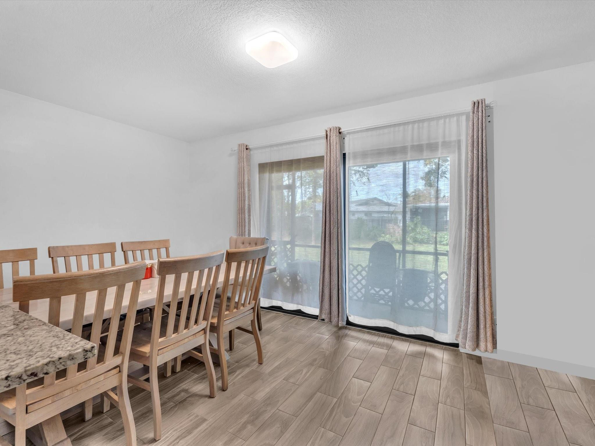 9831 Riverside Drive Coral Springs, FL 33071 - Photo 10 of 27 a view of a room with furniture wooden floor and window
