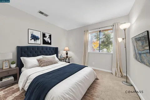 a bedroom with a large bed and a window