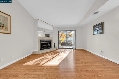 a view of empty room with wooden floor