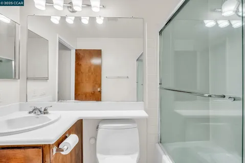 a bathroom with a sink a shower and a mirror