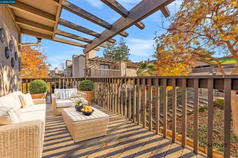 a view of balcony with wooden floor and outdoor seating