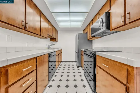 a view of a kitchen with microwave and cabinets