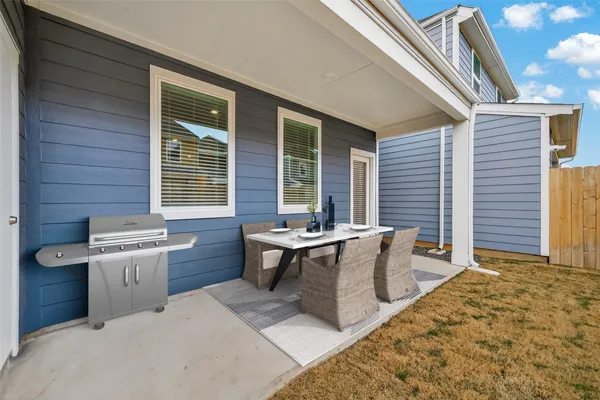 a view of a patio with table and chairs