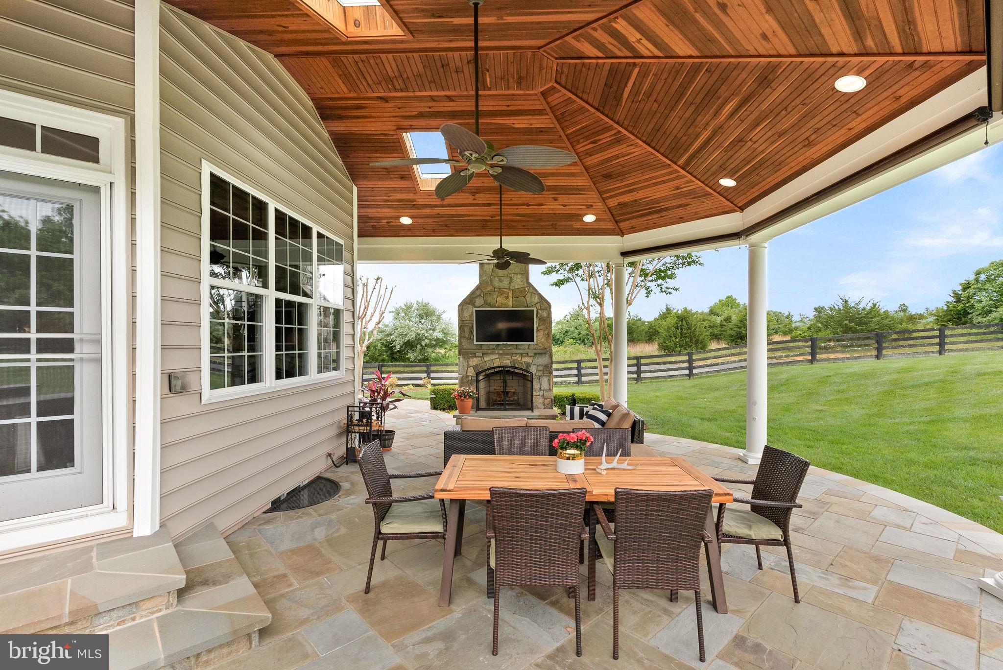 22415 Conservancy Drive Ashburn, VA 20148 - Photo 56 of 70 Covered Slate Patio with Stone Fireplace