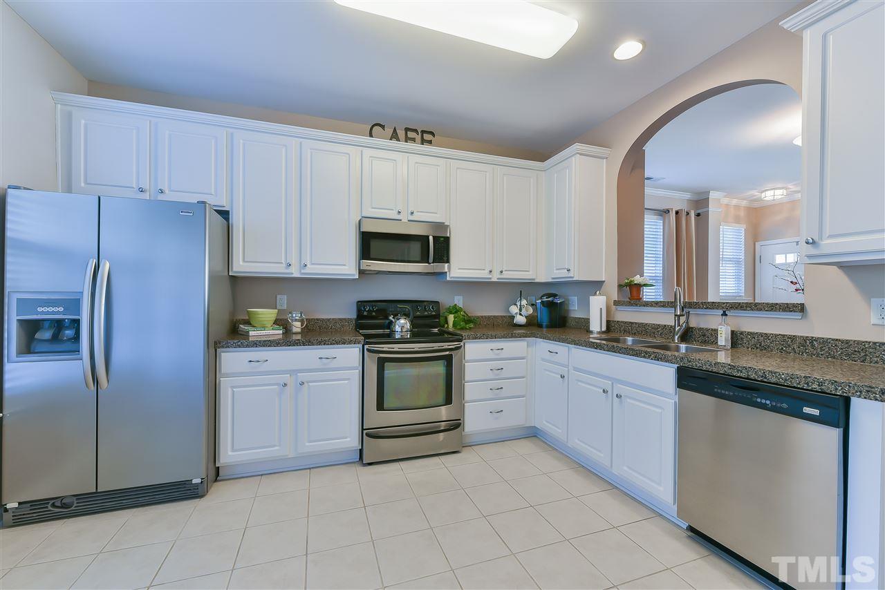 8240 City Loft Court Raleigh, NC 27613 - Photo 3 of 5 a kitchen with granite countertop cabinets stainless steel appliances and a counter space