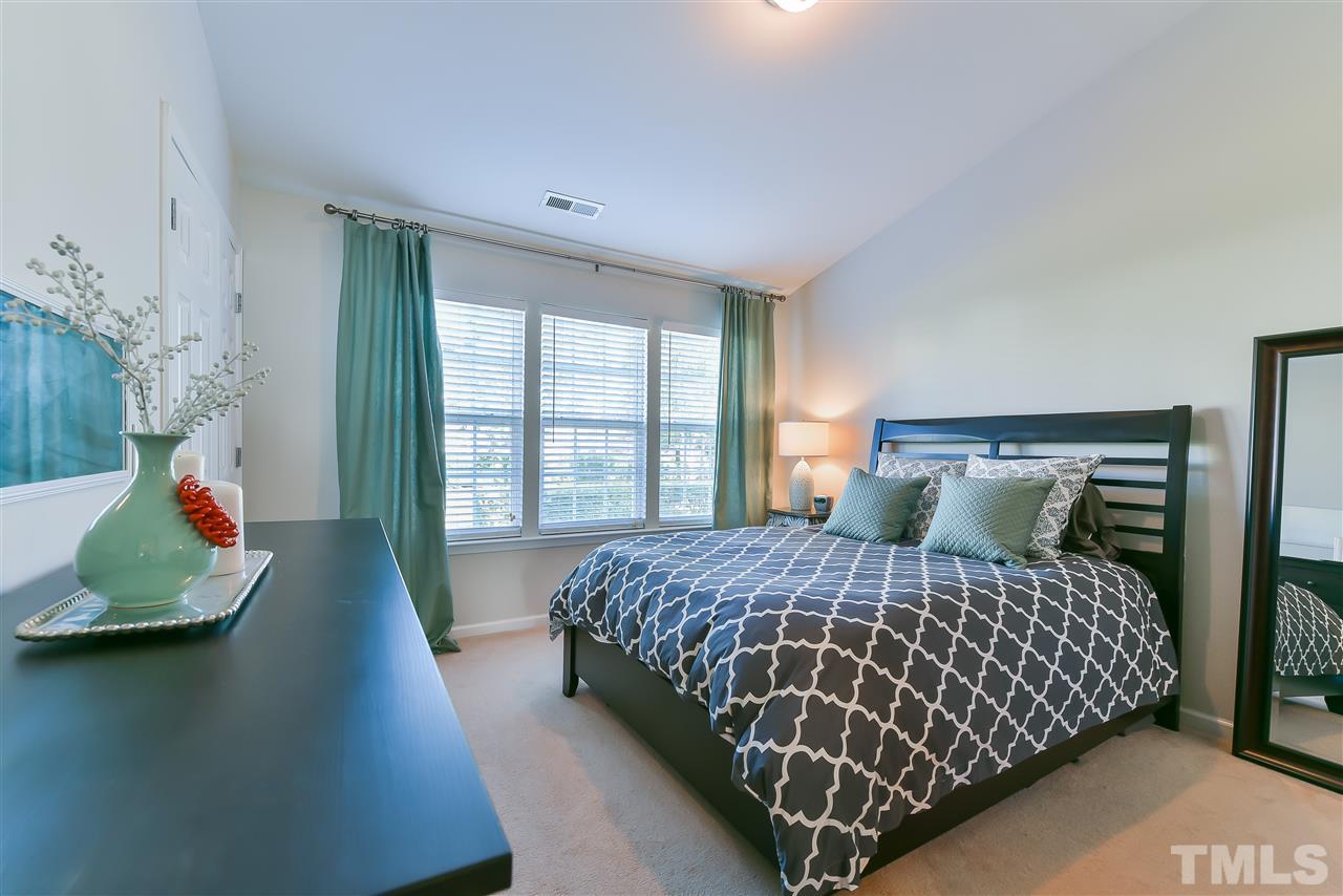 8240 City Loft Court Raleigh, NC 27613 - Photo 4 of 5 a bedroom with a bed and window