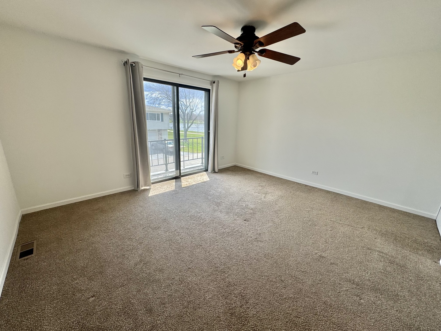 102 North Salem Drive, Unit 102 Schaumburg, IL 60193 - Photo 14 of 19 an empty room with a ceiling fan and a window