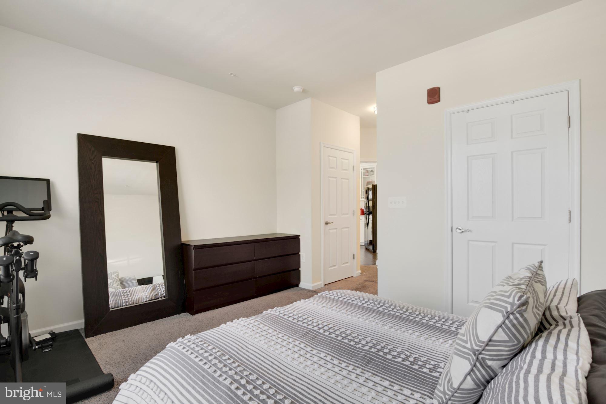 3825 Doc Berlin Drive, Unit 17 Silver Spring, MD 20906 - Photo 17 of 34 a bedroom with a bed and a mirror