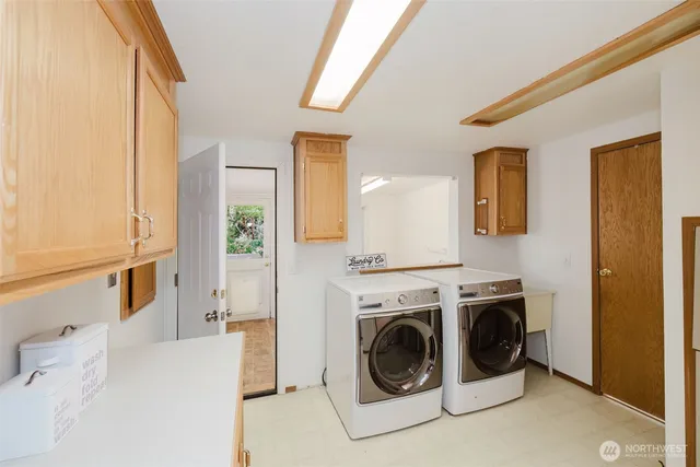 a view of a hallway with washer and dryer