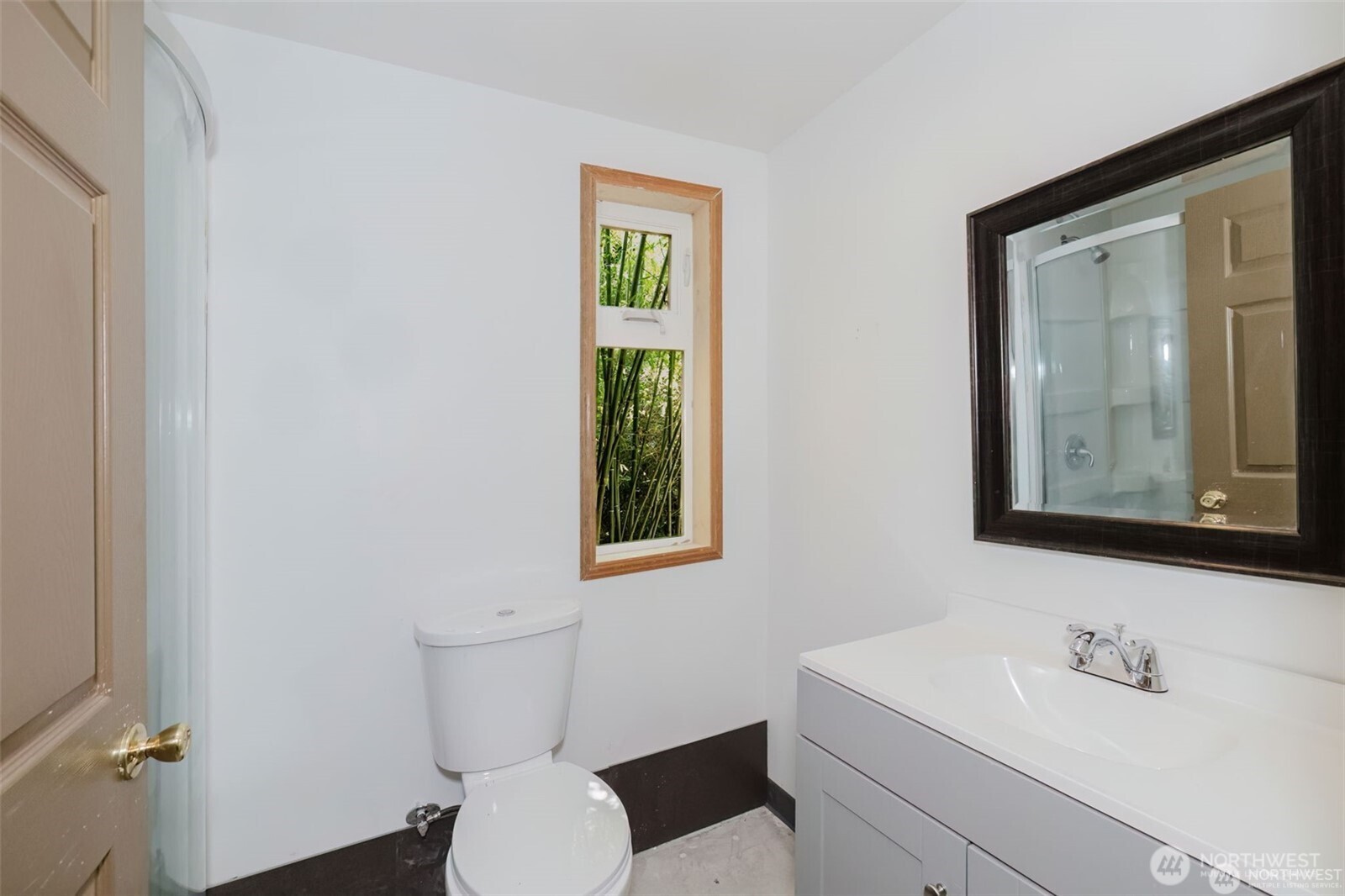 105 Schoolhouse Road Brinnon, WA 98320 - Photo 20 of 39 a bathroom with a toilet sink and mirror
