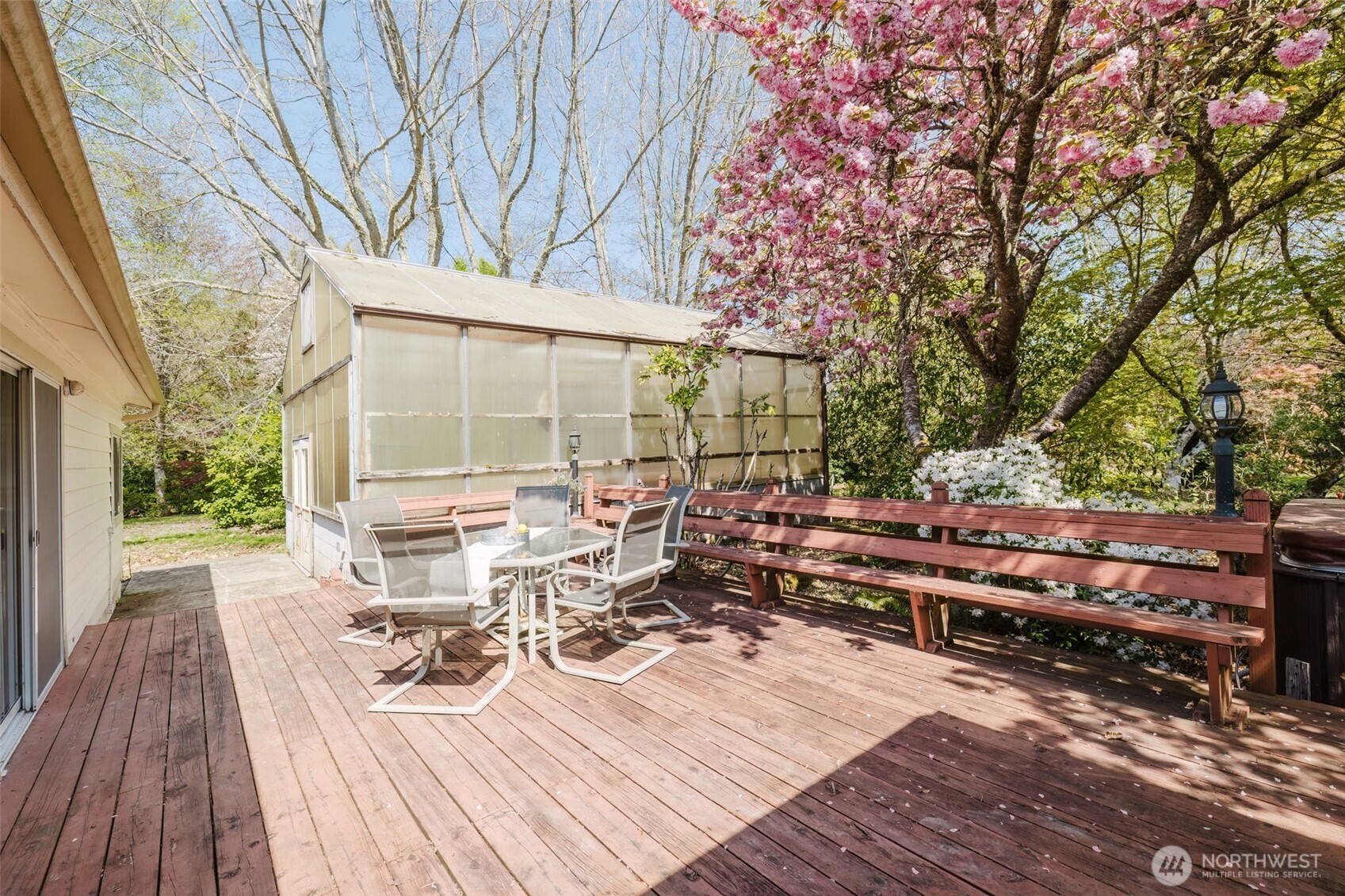 105 Schoolhouse Road Brinnon, WA 98320 - Photo 24 of 39 a view of a patio with wooden floor and outdoor seating